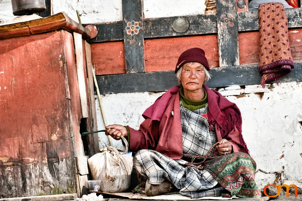Woman seated outside a building